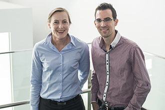 Two researchers standing smiling at camera