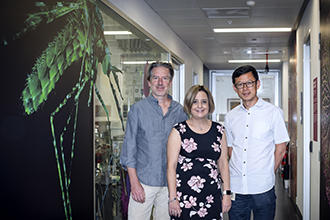 Three researchers smiling at camera