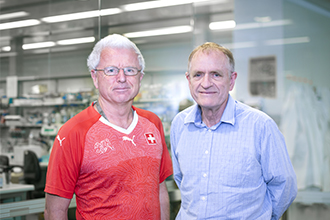 Two researchers standing outside lab