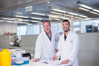 Dr Axel Kallies and Mr Kevin Man standing in a lab