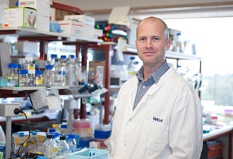 Dr Ben Kile standing in a laboratory