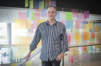 Associate Professor David Tarlinton standing in front of coloured boxes