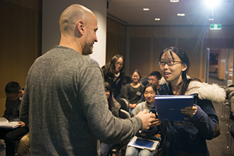 Prof Doug Hilton hands out welcome gifts