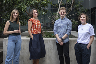 Photo of four scientists in a garden