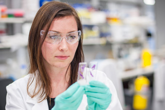 Ewa Michalak in lab examining plate