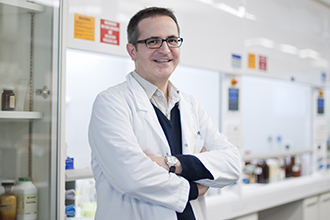 Associate Professor Guillaume Lessene standing in a laboratory