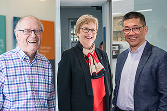 Three researchers smiling at camera