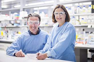 Dr Axel Kallies and Dr Diana Hansen pictured in lab, smiling at camera