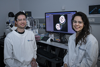 Smiling researchers with microscope