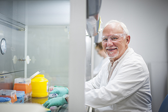 Professor Len Harrison standing in laboratory