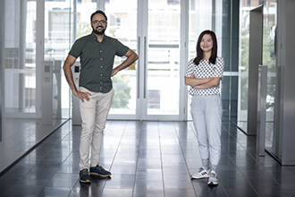 Two scientists smiling at the camera