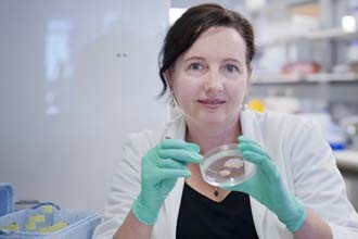Dr Lorraine O'Reilly holding a petri dish