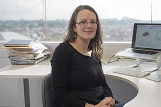 Dr Marnie Blewitt in front of her computer