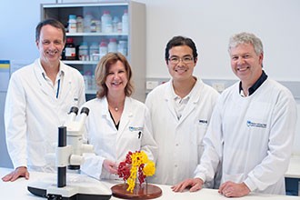 Associate Professor Mike Lawrence, Ms Mai Margetts, Dr Geoffrey Kong and Dr John Menting with a model of the insulin receptor