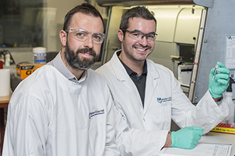 Researchers in the lab, smiling