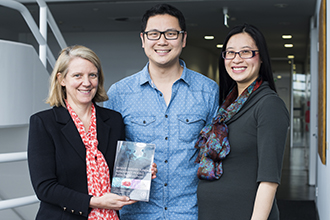 Researchers holding book