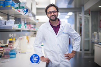 Dr Shalin Naik in a lab with his award