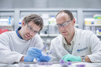 Scientists looking at sample in a lab