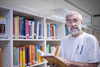 Terry Speed looking at a book