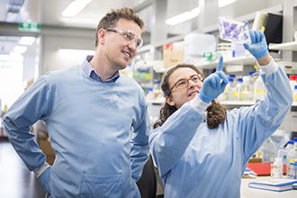 Two researchers in the lab looking at an experiment