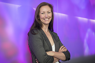 Scientist standing smiling at camera