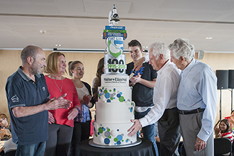 Institute staff cutting 100th birthday cake