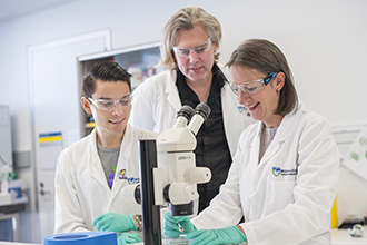 Researchers using microscope