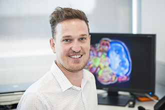 Smiling researcher with computer