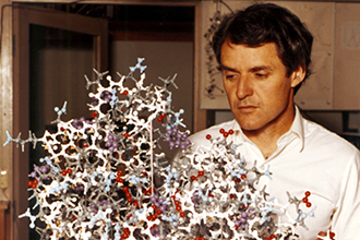 Professor Peter Colman with a protein structure