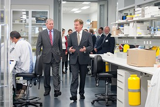 Hon David Davis and Hon Peter Ryan walking through lab