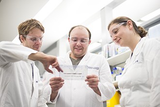 Mr James Rickard, Mr Joseph Evans and Ms Joanne O'Donnell looking at gel photo