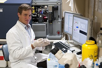 Dr John Wentworth in front of lab computer