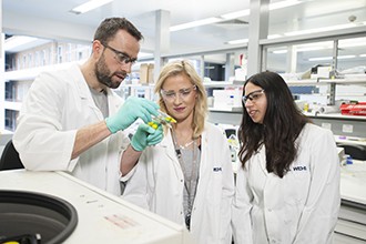 Dr Nick Huntington, Ms Rebecca Delconte and Dr Priyanka Sath with test tube