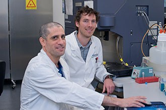 Seth Masters and Motti Gerlic in lab at desk