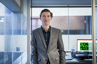 A/Prof Seth Masters standing in an office