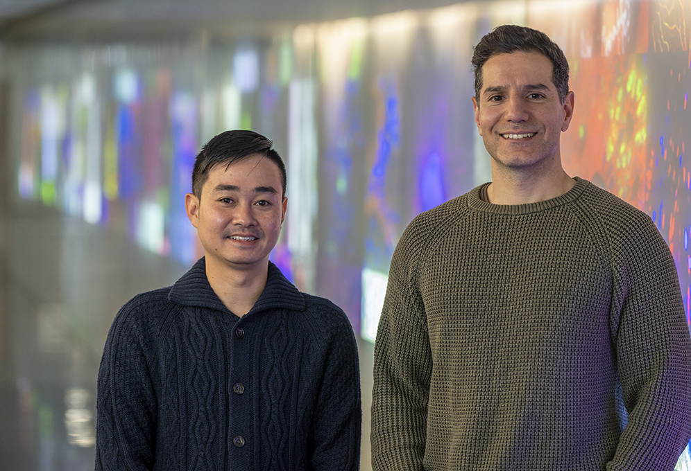 Dr Thanh Nguyen and Assoc Prof Michael Lazarou photographed with a colourful background