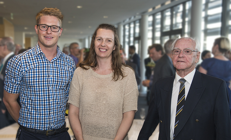 A woman with a young to her right and an older man to her left