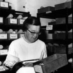 Dr Margaret Holmes looking into a box 1966