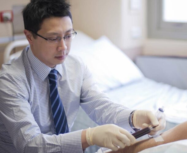 Jason Tye-Din takes a blood sample for research into coeliac disease and how it is caused.