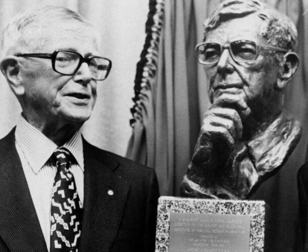 Sir Frank Macfarlane Burnet with a bronze bust of himself, created by the portrait sculptor Arnold Bonnet at the unveiling ceremony.