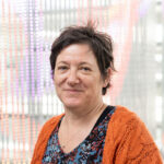 Photo of Isabelle Lucet with colourful LED lights in the background