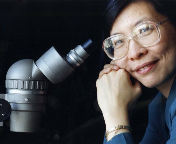 Professor Li Wu with a microscope