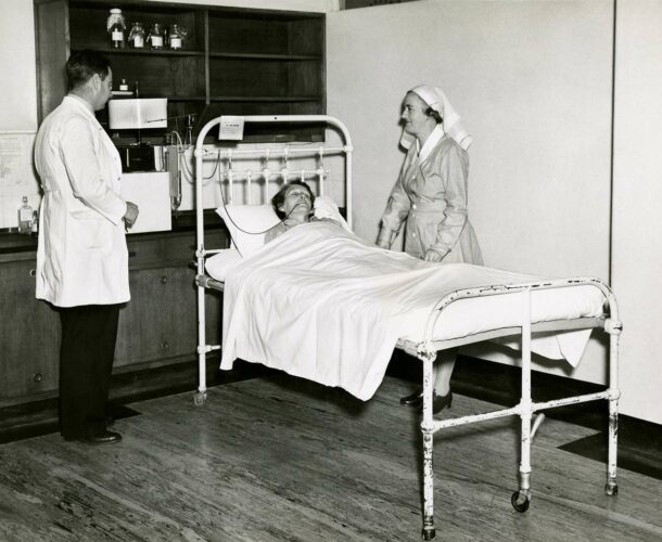 Institute scientist and hospital nurse attend to a patient in the Clinical Research Unit.