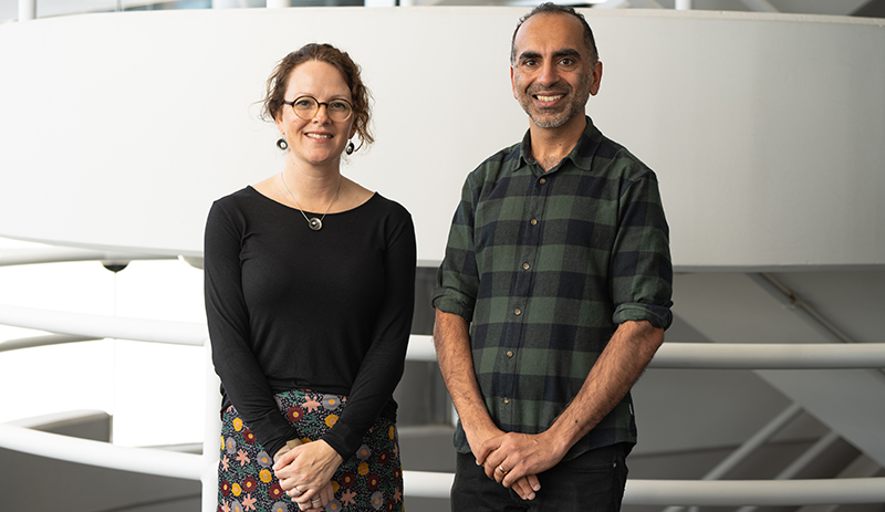 Professor Marnie Blewitt (left) and Professor Sant-Rayn Pasricha (right) posing for a photo in front of a staircase