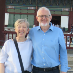 Photo of a woman and man wearing casual clothes smiling at the camera