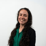 Ana Maluenda wearing a black cardigan and dark green shirt