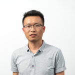 Leo Liu wearing glasses and a light grey polo t-shirt