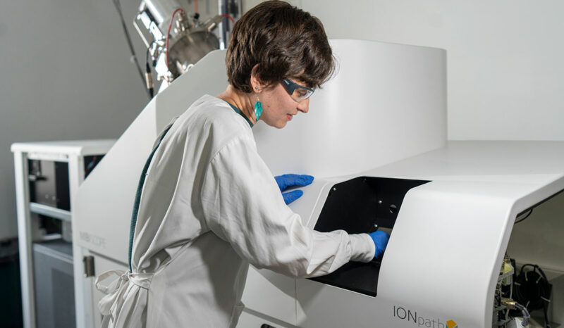 A scientist is photographed using the MIBIscope proteomic technology
