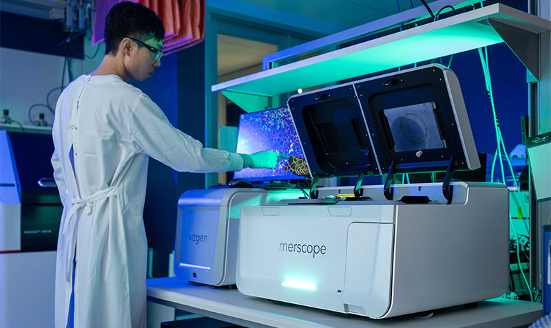 A researcher is photographed using advanced scientific equipment