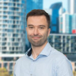 Portrait photo of Lee Booty with a cityscape in the background